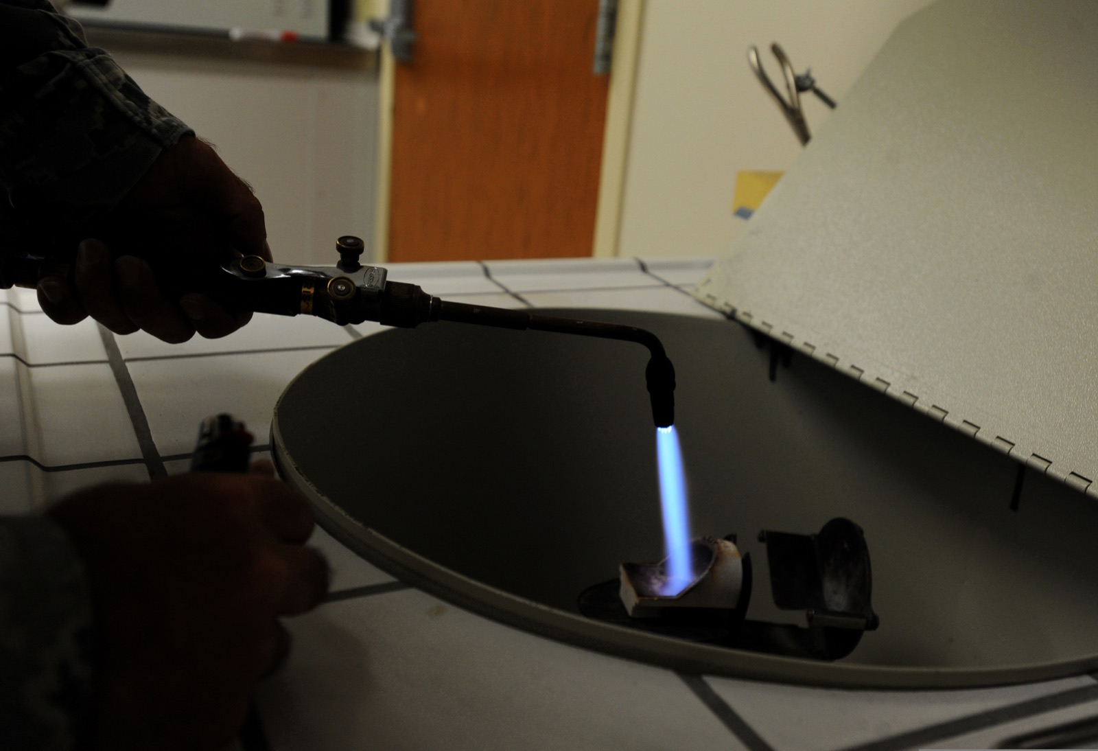 Photograph: dental laboratory technician melting gold with a torch